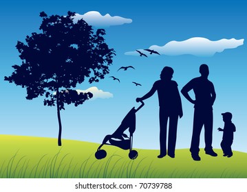 family with little child on summer field near tree with carriage, blue sky