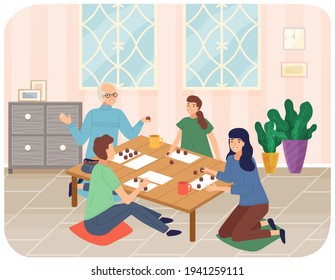 Family mother, daughter, grandparents sitting at table playing board game or tabletop game lotto