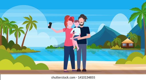 family on beach taking selfie photo on smartphone camera summer vacation concept mother father and son standing together tropical island seaside background full length horizontal