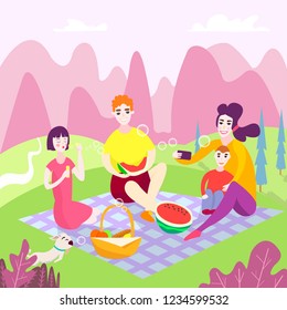 Family picnic in the park. Spring vacation. Happy family with children. They sit and eat watermelon on the grass in the park, a basket with food and toys for children. make selfies. 