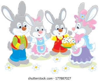 Family of rabbits with an Easter cake