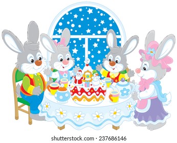 Family of rabbits at the holiday table with a Christmas cake 