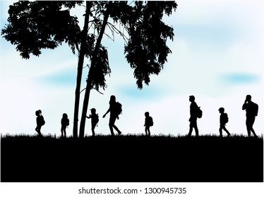 Family reaching with backpacks on a trip.
