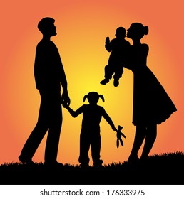 Family Silhouette In The Sunset