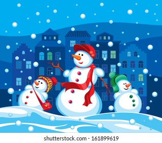 family of snowmen in the evening city