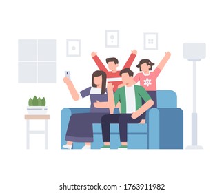A family is taking a selfie together at home