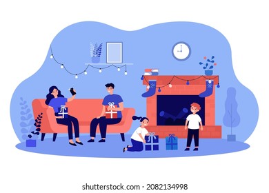 Family unpacking Christmas gifts by fireside. Parents and children holding their presents flat vector illustration. Winter holidays celebrating concept for banner, website design or landing web page