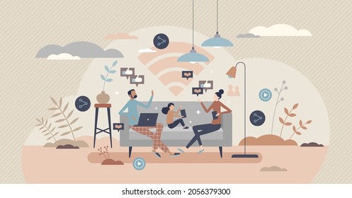 Family using internet at home while sitting on couch, tiny person concept. Spending time online together indoors. Mother, father and kid with mobile gadgets. Wireless connection and modern life tech.