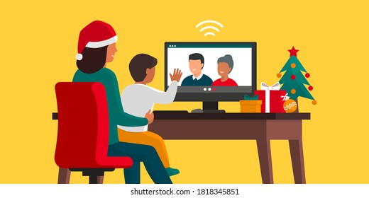 Family videocalling at Christmas: a mother is holding her son and videocalling grandparents