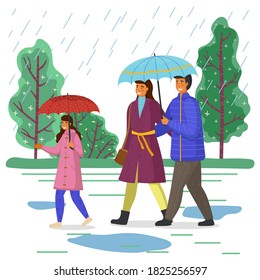 Family walks while raining.  Parents under blue umbrella. City autumn park, puddles, rain. Be happy with your family even in bad weather. Autumn time
