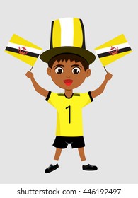 Fan of Brunei national football team, sports. Boy with flag in the colors of the national command with sports paraphernalia.