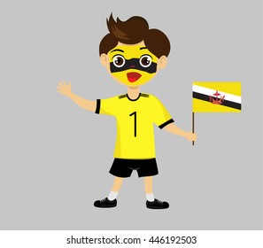 Fan of Brunei national football team, sports. Boy with flag in the colors of the national command with sports paraphernalia.