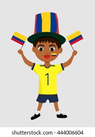 Fan of Colombia national football team, sports. Boy with flag in the colors of the national command with sports paraphernalia.