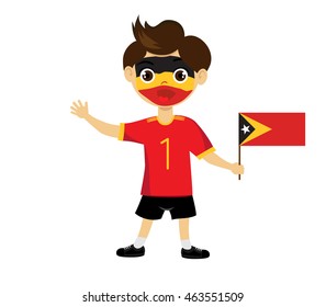 Fan of East Timor national football team, sports. Boy with flag in the colors of the state command with sports paraphernalia.