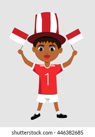 Fan of Indonesia national football team, sports. Boy with flag in the colors of the national command with sports paraphernalia.