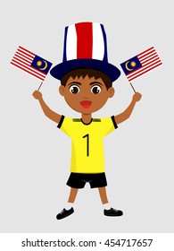 Fan of Malaysia national football team, sports. Boy with flag in the colors of the state command with sports paraphernalia.