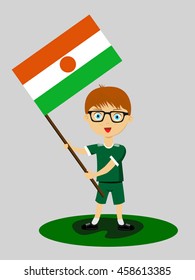 Fan of Niger national football team, sports. Boy with flag in the colors of the state command with sports paraphernalia.