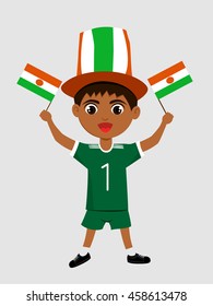 Fan of Niger national football team, sports. Boy with flag in the colors of the state command with sports paraphernalia.