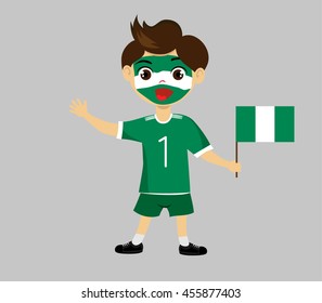 Fan of Nigeria national football team, sports. Boy with flag in the colors of the state command with sports paraphernalia.