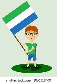 Fan of Sierra Leone national football, hockey, basketball team, sports. Boy with Sierra Leone flag in the colors of the national command with sports paraphernalia. Boy with Sierra Leone flag