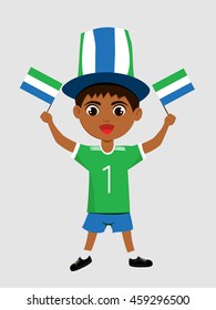 Fan of Sierra Leone national football team, sports. Boy with flag in the colors of the state command with sports paraphernalia.