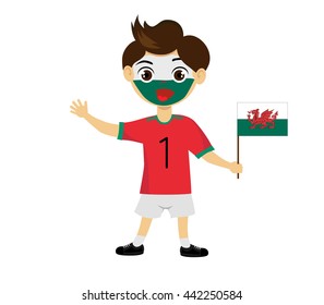 Fan of Wales national football team, sports. Boy with flag in the colors of the national command with sports paraphernalia. 