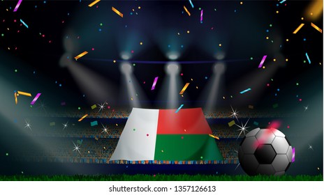 Fans hold the flag of Madagascar among silhouette of crowd audience in soccer stadium with confetti to celebrate football game. Concept design for football result template