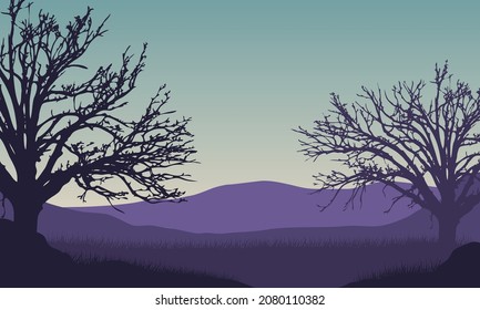 A fantastic view of the mountains with dry tree silhouettes from the village at sunrise in the morning. Vector illustration of a city