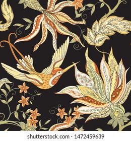 Fantasy flowers, traditional Jacobean embroidery style. Seamless pattern, background. Embroidery imitation. Vector illustration in soft orange and green colors isolated on black background.