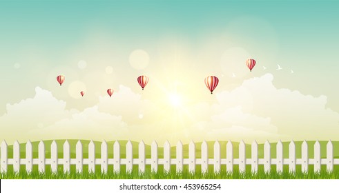 Fantasy Vector Landscape Background, Sunset and hot air ballons on cloudy sky and grass field with wooden fance.
