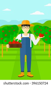 Agricultor recogiendo manzanas.