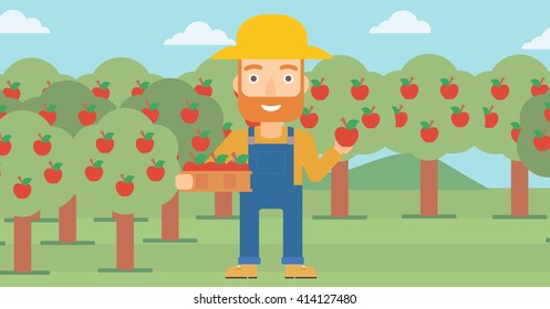 Agricultor recogiendo manzanas.
