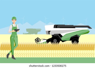 Farmer controls an autonomous combine harvester. Internet of things in agriculture