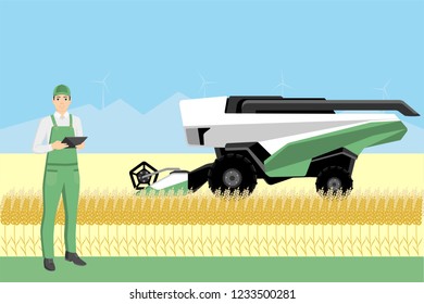 Farmer controls an autonomous combine harvester. Internet of things in agriculture