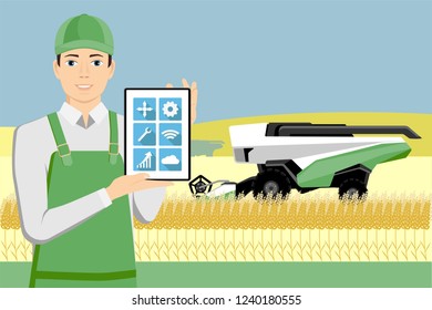 Farmer controls an autonomous combine harvester with digital tablet via satellite. Internet of things in agriculture