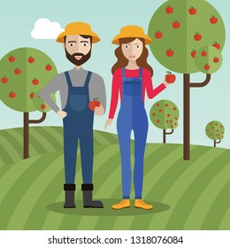 Farmer couple at the field collecting apples