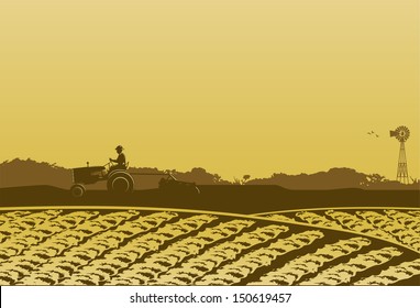 Farmer in farm field at sunset 