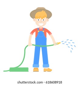 Farmer in hat dressed in a blue jumpsuit watering with hoses