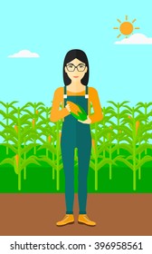 Farmer holding corn.