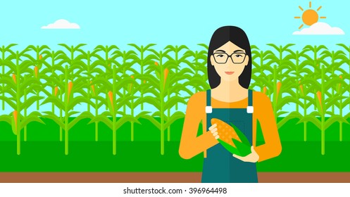 Farmer holding corn.