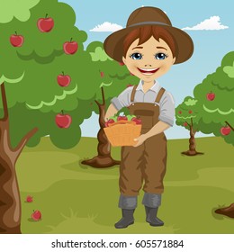 farmer little boy picking apples holding basket standing in orchard