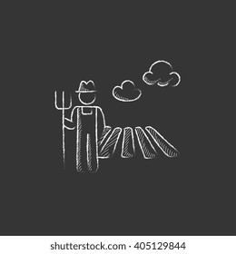 Farmer with pitchfork. Drawn in chalk icon.