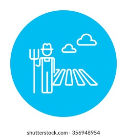 Farmer with pitchfork standing on the field line icon for web, mobile and infographics. Vector white icon on the light blue circle isolated on white background.