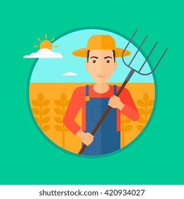Farmer with pitchfork in wheat field.