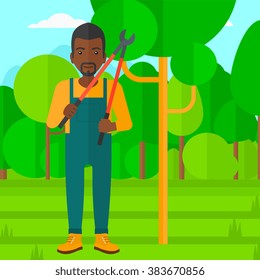 Farmer with pruner in garden.