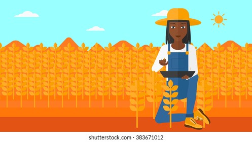 Farmer with tablet computer on field.