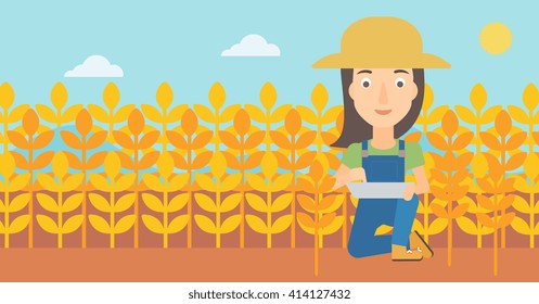 Farmer with tablet computer on field.