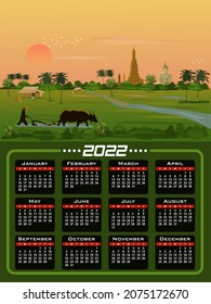 A farmer is using buffalo to shovel the soil in a rice field with a big Buddha image and the morning sun in the background.Calendar 2020 - all the year round - four seasons and 12 months of the year.
