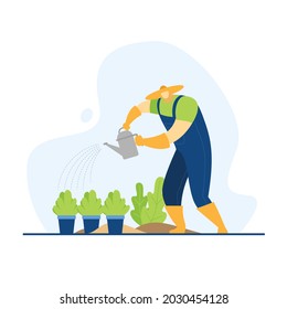 Farmer watering plants in pots in the garden