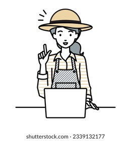 a farmer woman using laptop computer getting ideas with pointing hand gesture at her desk